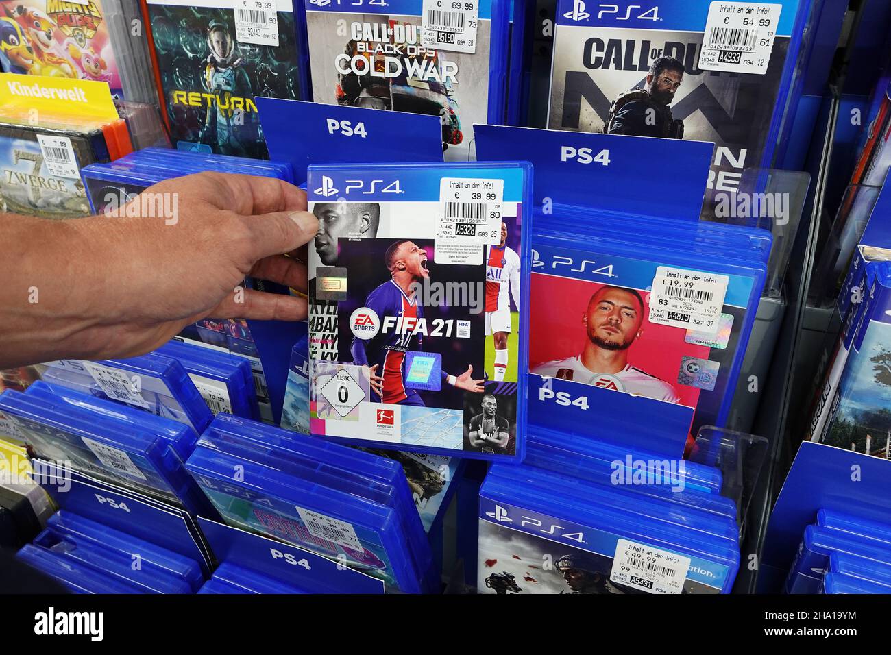 Store display filled with PlayStation 4 games for a home video game console. Stock Photo