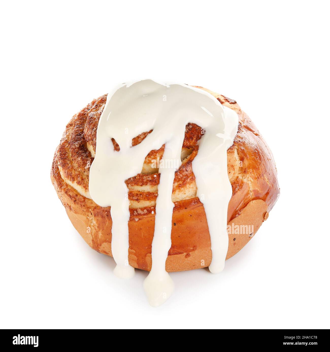 Tasty cinnamon roll with cream on white background Stock Photo - Alamy