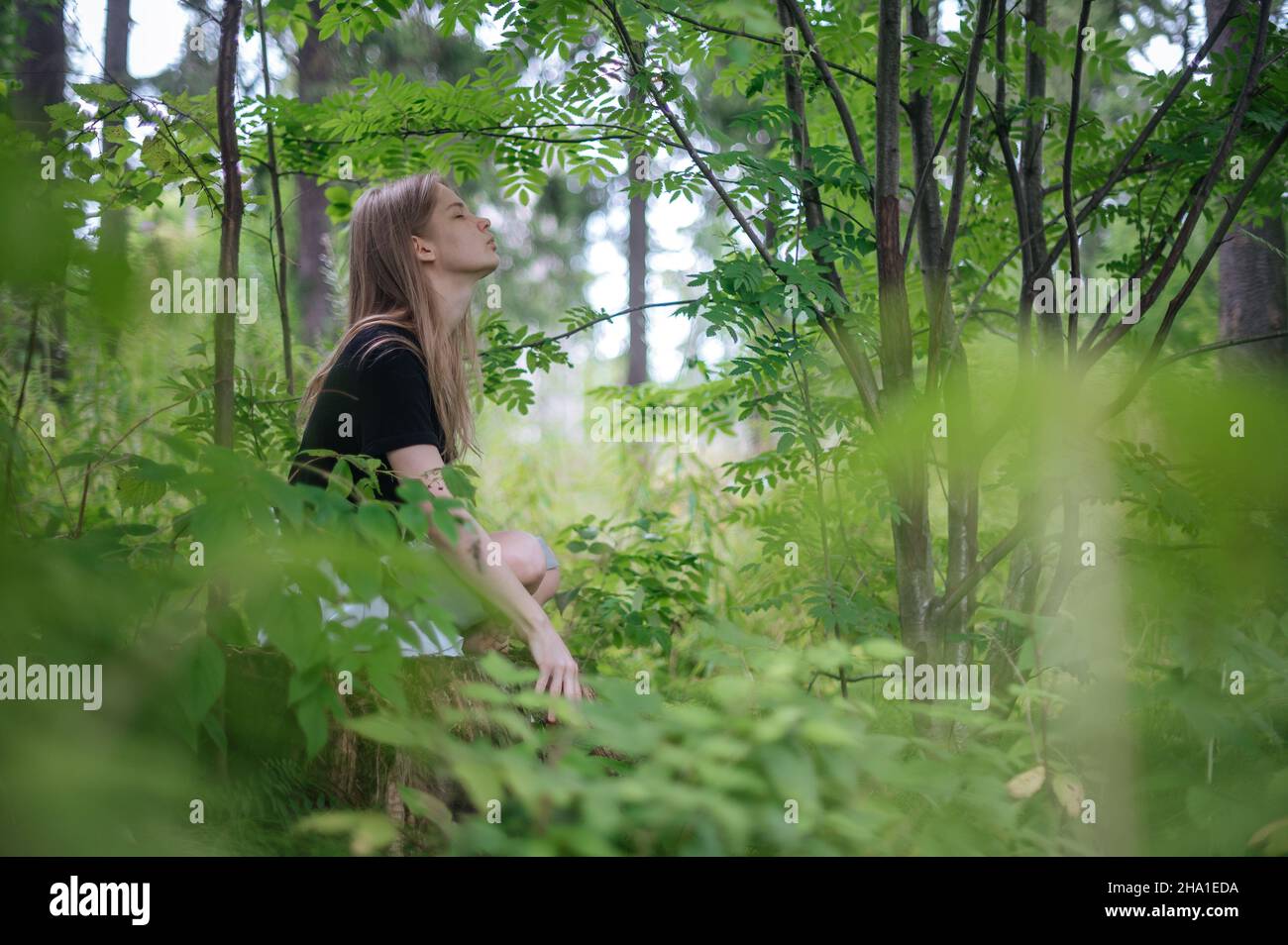 Practice of meditation and interaction with nature. Girl in green ...