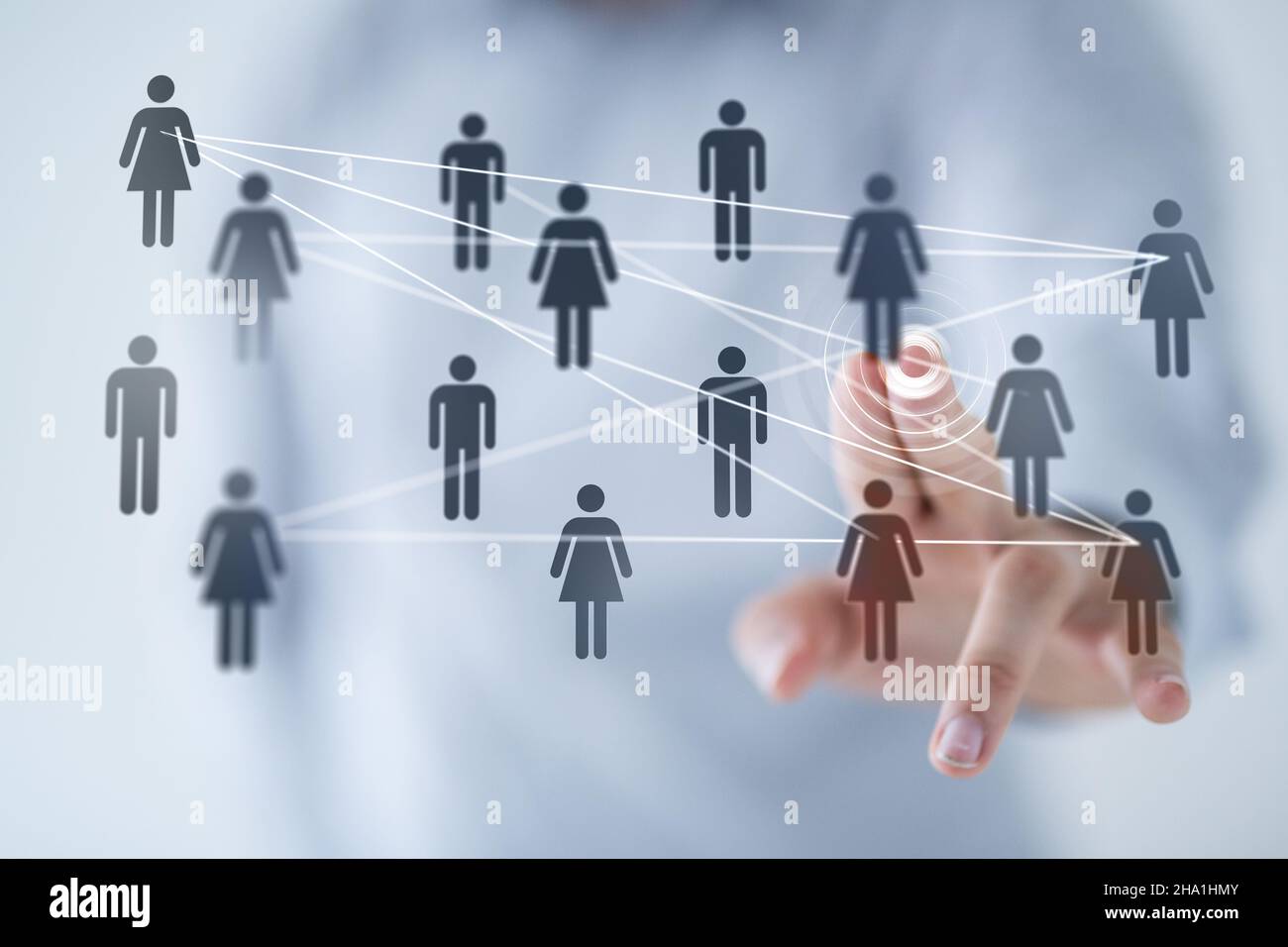 Man tapping on 3D rendered people icons Stock Photo - Alamy