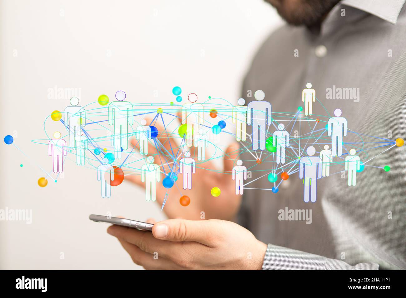 Group of 3D rendered people icons hovering over a man's hand holding a ...