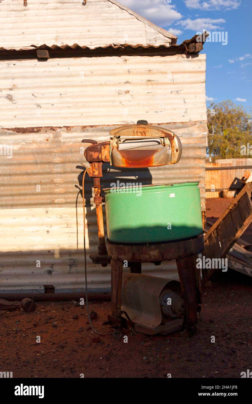 Corrugated iron building and washing machine of  the historical gold mining town Gwalia, Leonora, Western Australia Stock Photo