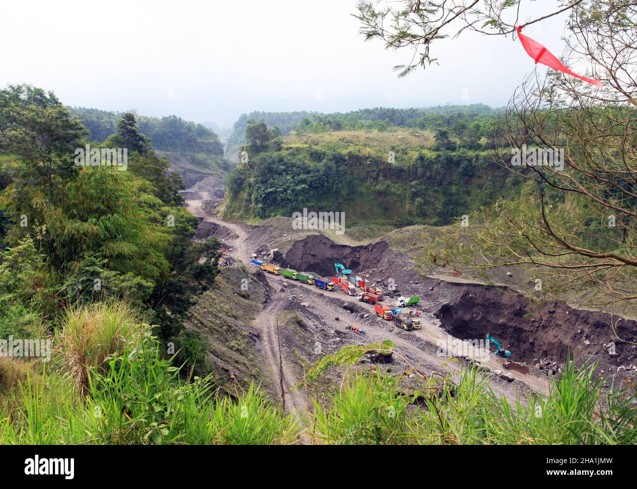 Quarrying away the volcanic lava stone from a ravine on the flanks of Mount Merapi in Yogyakarta, Central Java, Indonesia. Stock Photo