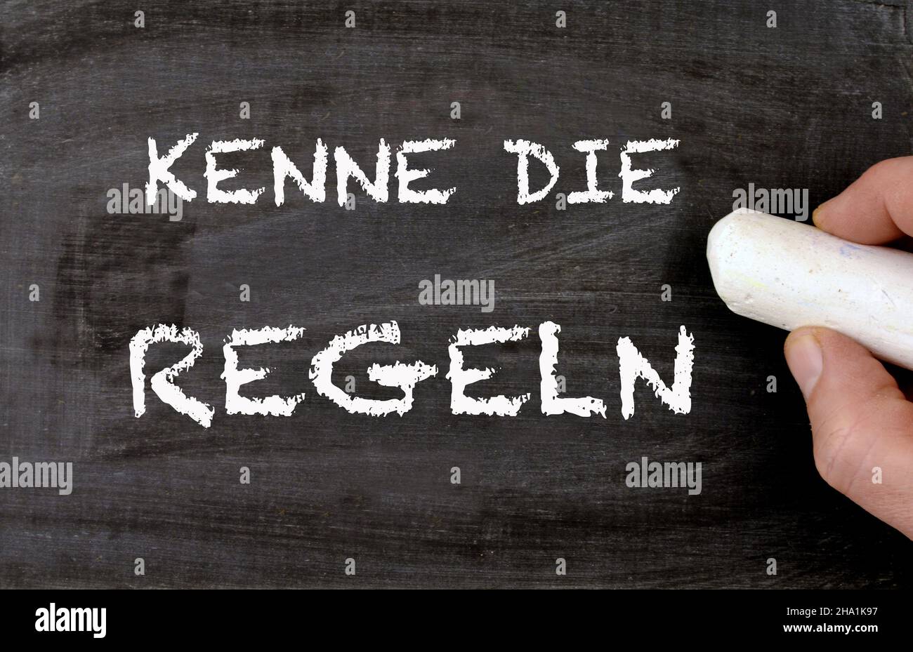Blackboard handwritten Know the Rules in german Kenne die Regeln Stock Photo