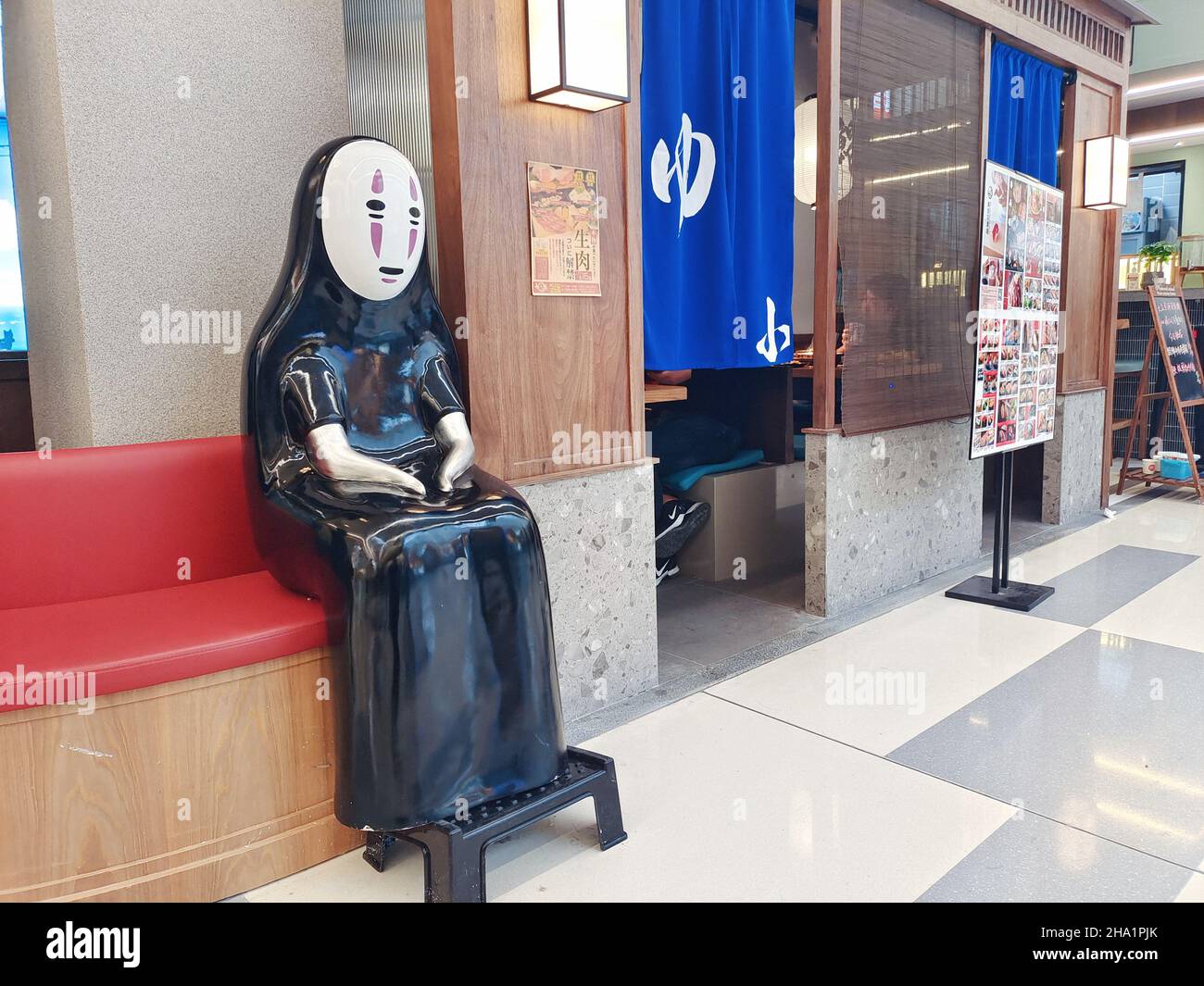 SHANGHAI, CHINA - NOVEMBER 28, 2021 - The faceless Man (sculpture), a character from Japanese animation master Hayao Miyazaki's Oscar-winning animated Stock Photo
