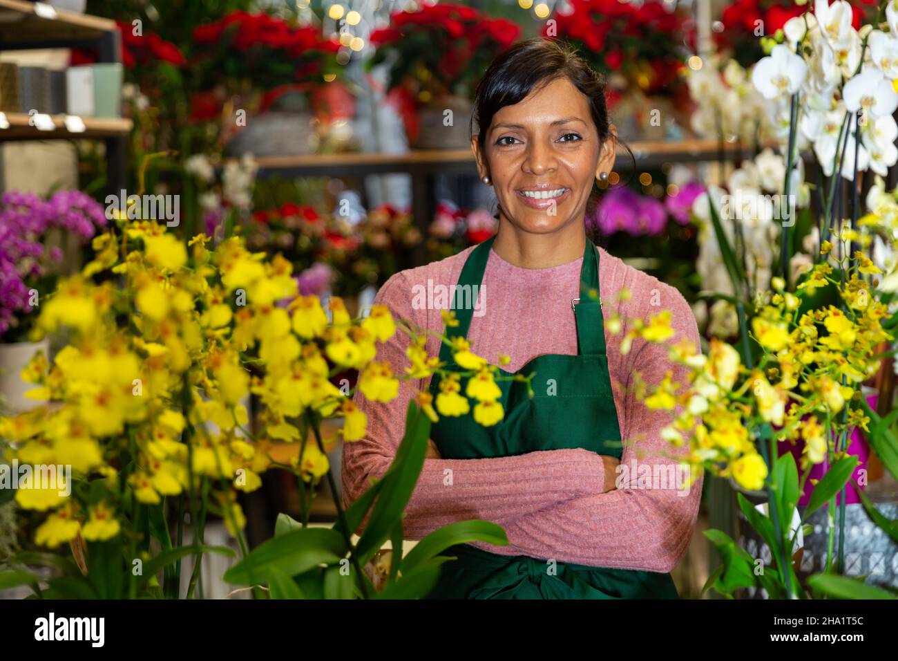 Woman seller posing with orchids in pots Stock Photo
