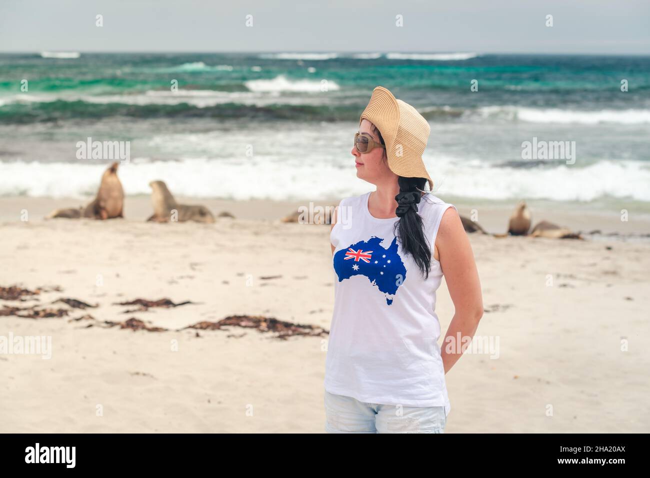 Young woman watching sea lions at Seal Bay, Kangaroo Island, South Australia Stock Photo