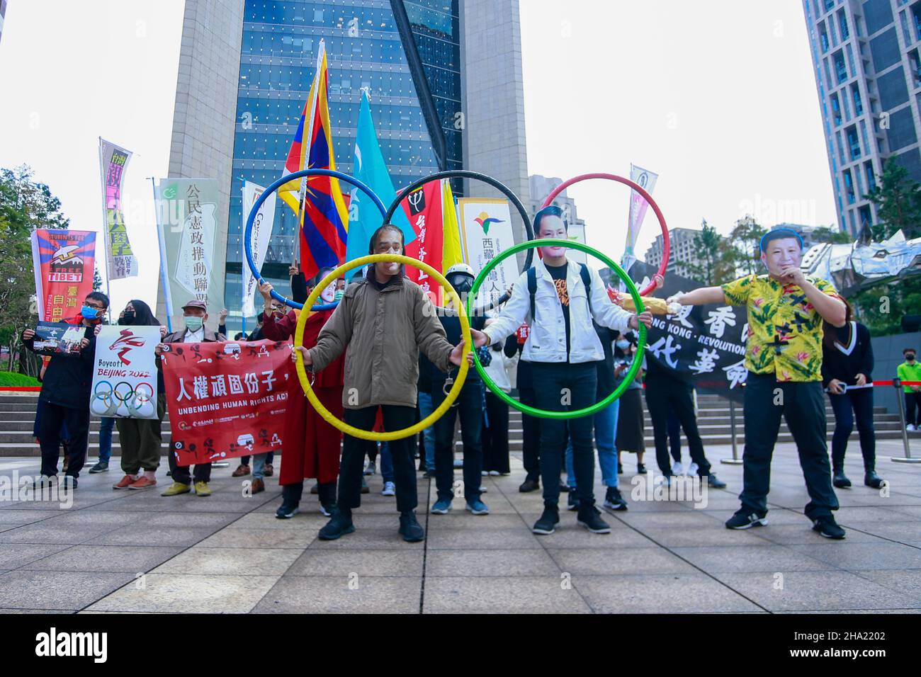 Taipei, Taipei, Taiwan. 10th Dec, 2021. Demonstrators holding The Olympic Rings, one wearing a mask with the face of Chinese president Xi Jinping during a protest boycotting the Beijing Winter Games 2022, outside the Bank of China (Taipei Branch), following several diplomatic boycotts of the Games. The United States, Canada, UK, and Australia have pledged not to send officials to attend the Games as a mean to boycott the China, following the disappearance of Chinese tennis player Peng Shuai and human rights crackdowns on Hong Kong and Xinjiang. (Credit Image: © Daniel Ceng Shou-Yi/ZUMA Pres Stock Photo