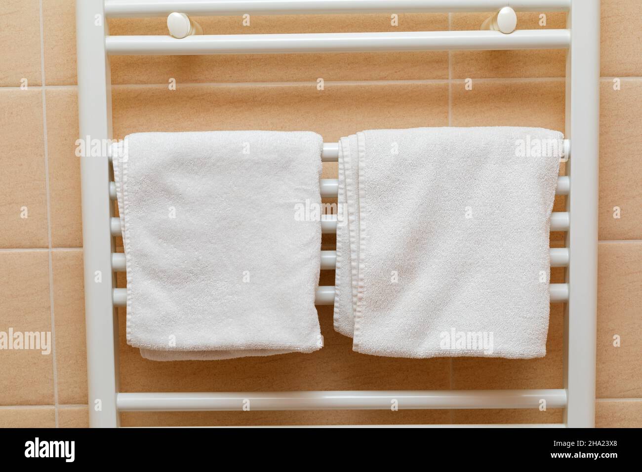 Clean white towels on a radiator in a bathroom Stock Photo - Alamy