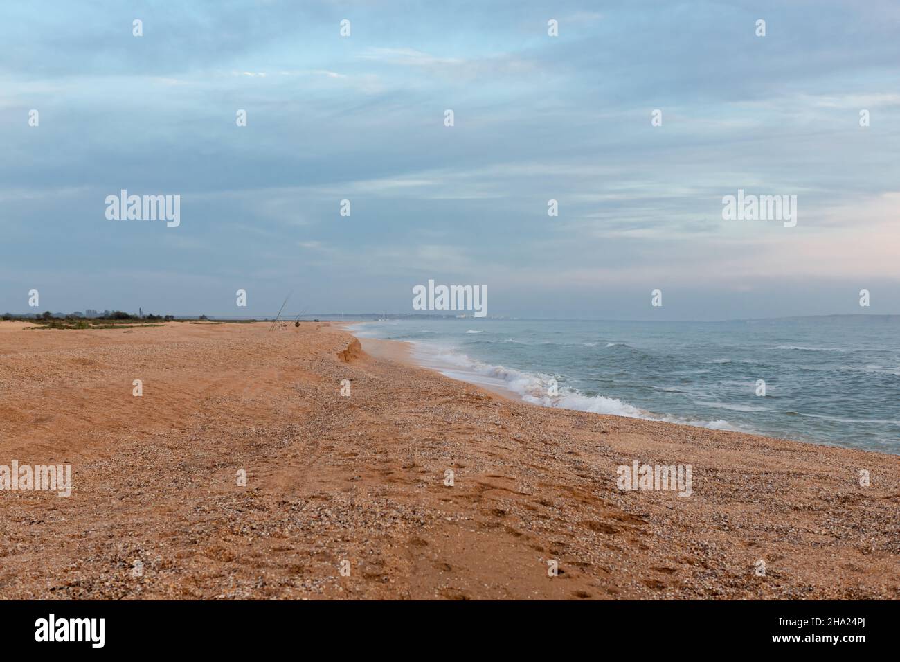 Cloudy sky on the light by the sea, fishermen with fishing rods, landscape. Russia, sea of Azov, summer. Stock Photo