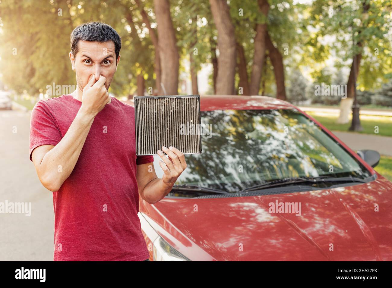 Frustrated car driver with an allergy to dust collected in an old dirty