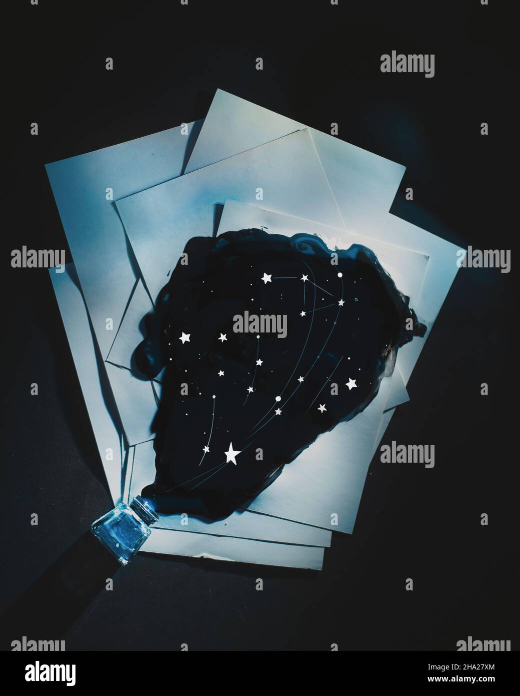 Spilled ink with constellations, starry sky on writer's desk ...