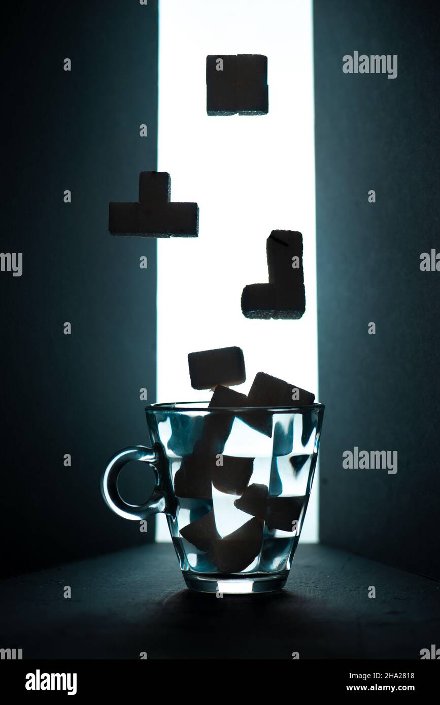 Tea Tetris, sugar cube Tetris figures on a dark background Stock Photo