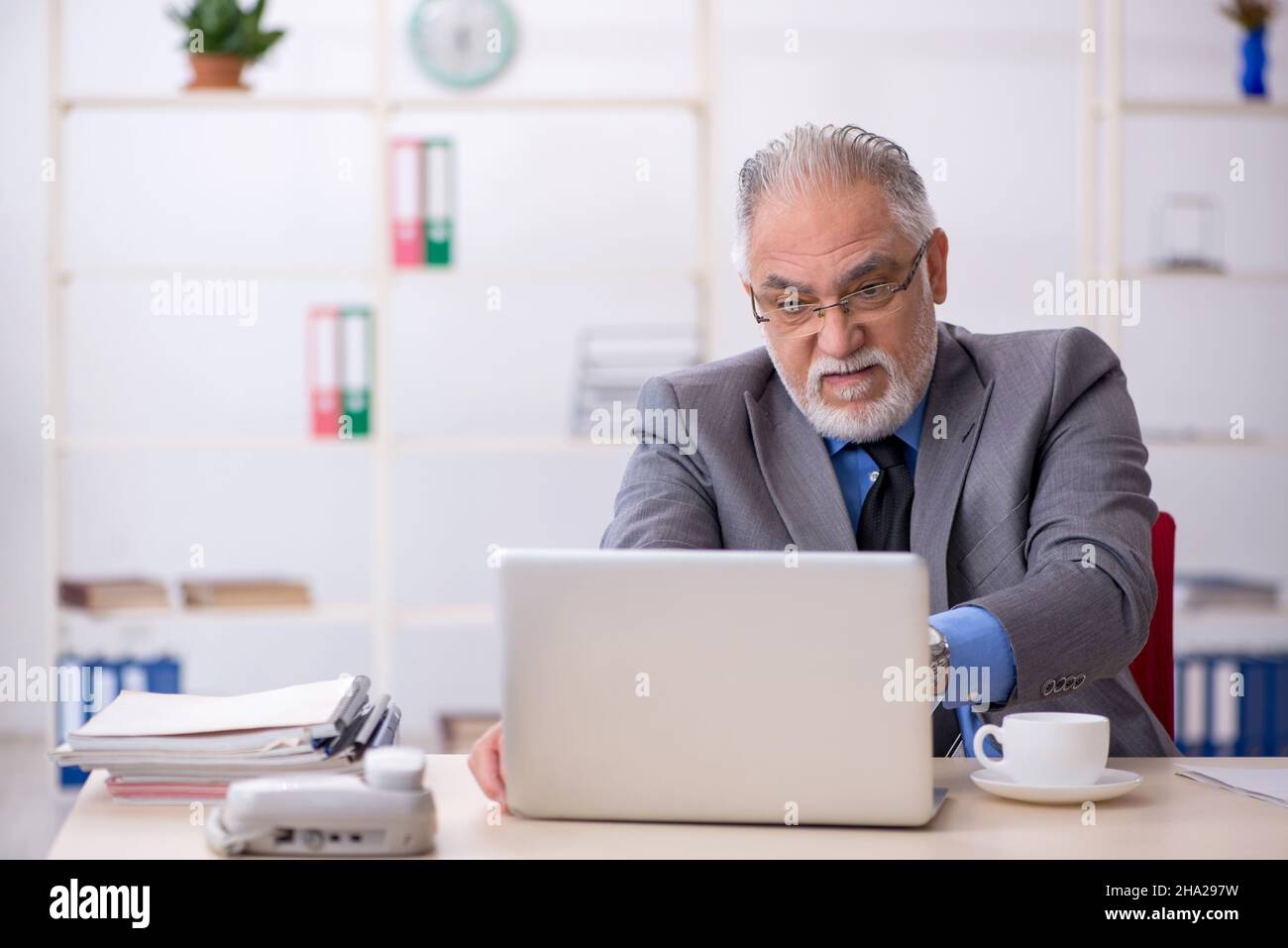 Old businessman employee working at workplace Stock Photo - Alamy