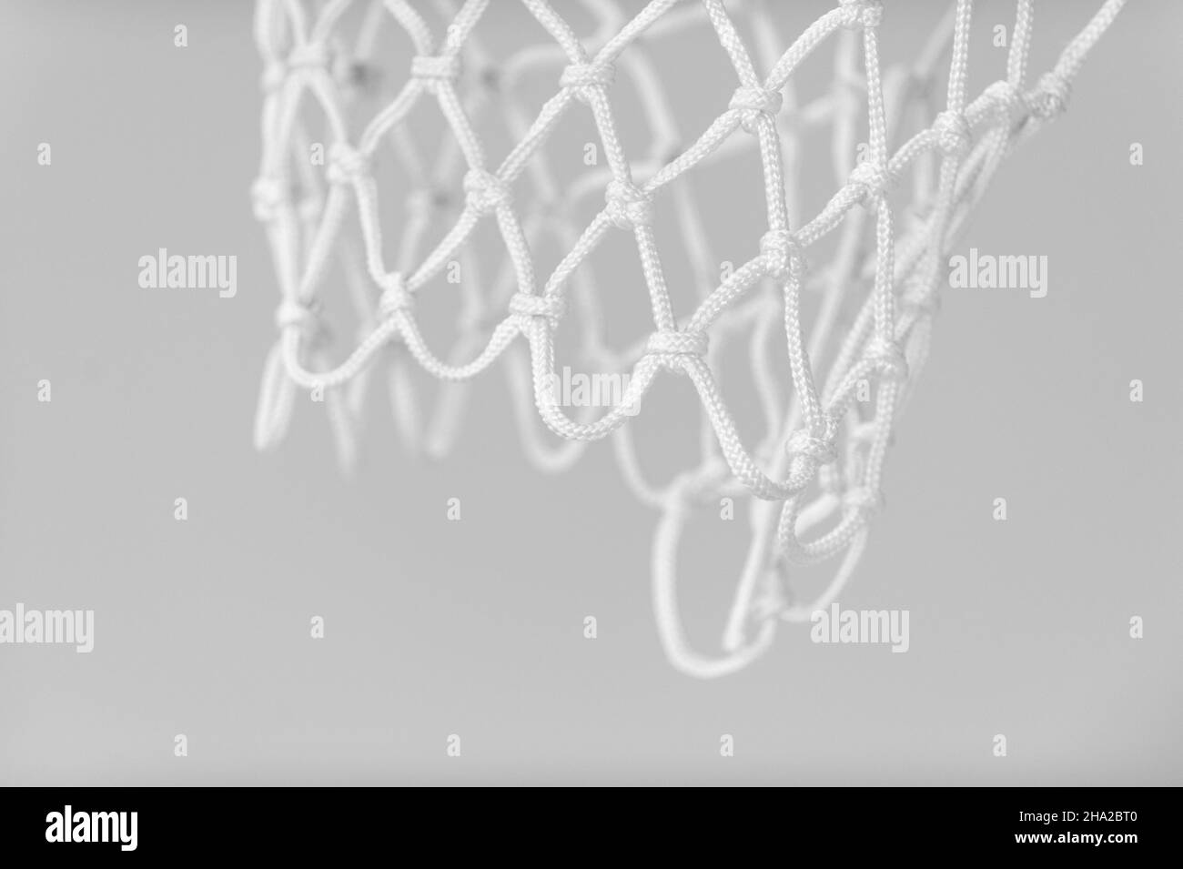 Empty Swooshing Basketball Net Close Up with gray background. Horizontal sport theme poster, greeting cards, headers, website and app Stock Photo
