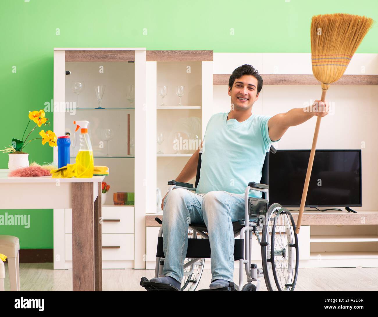 The disabled man on wheelchair cleaning house Stock Photo Alamy