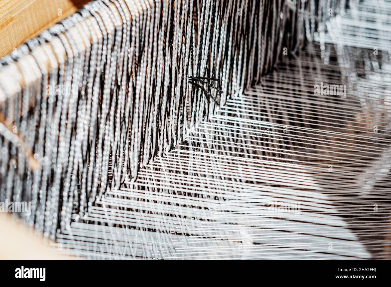 spinning cotton thread with a wooden retro craftsman spinner machine