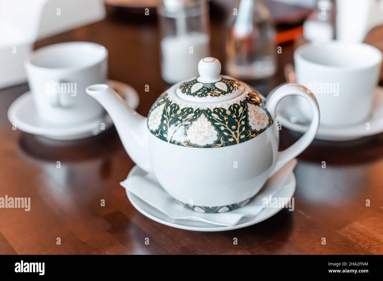 Teapot and two cups on a table in cafe Stock Photo