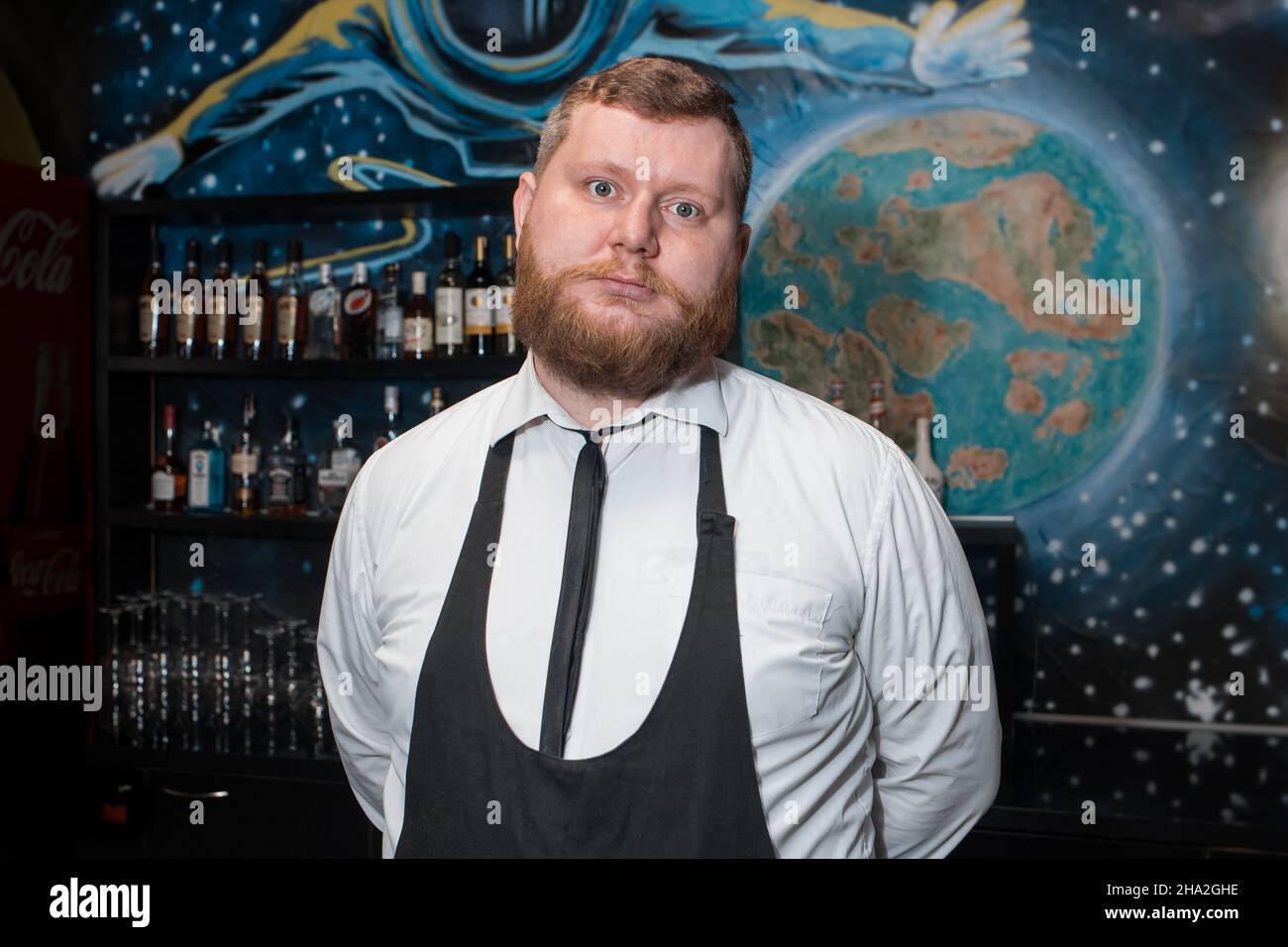 Bearded Adult Caucasian Looking Professional Bartender Portrait in Nightclub. Stock Photo