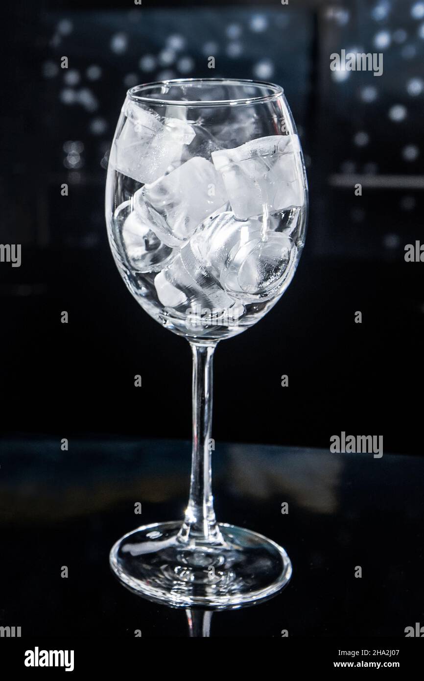 Ice cubes frozen cold ice water liquid white in a glass glass on the ...