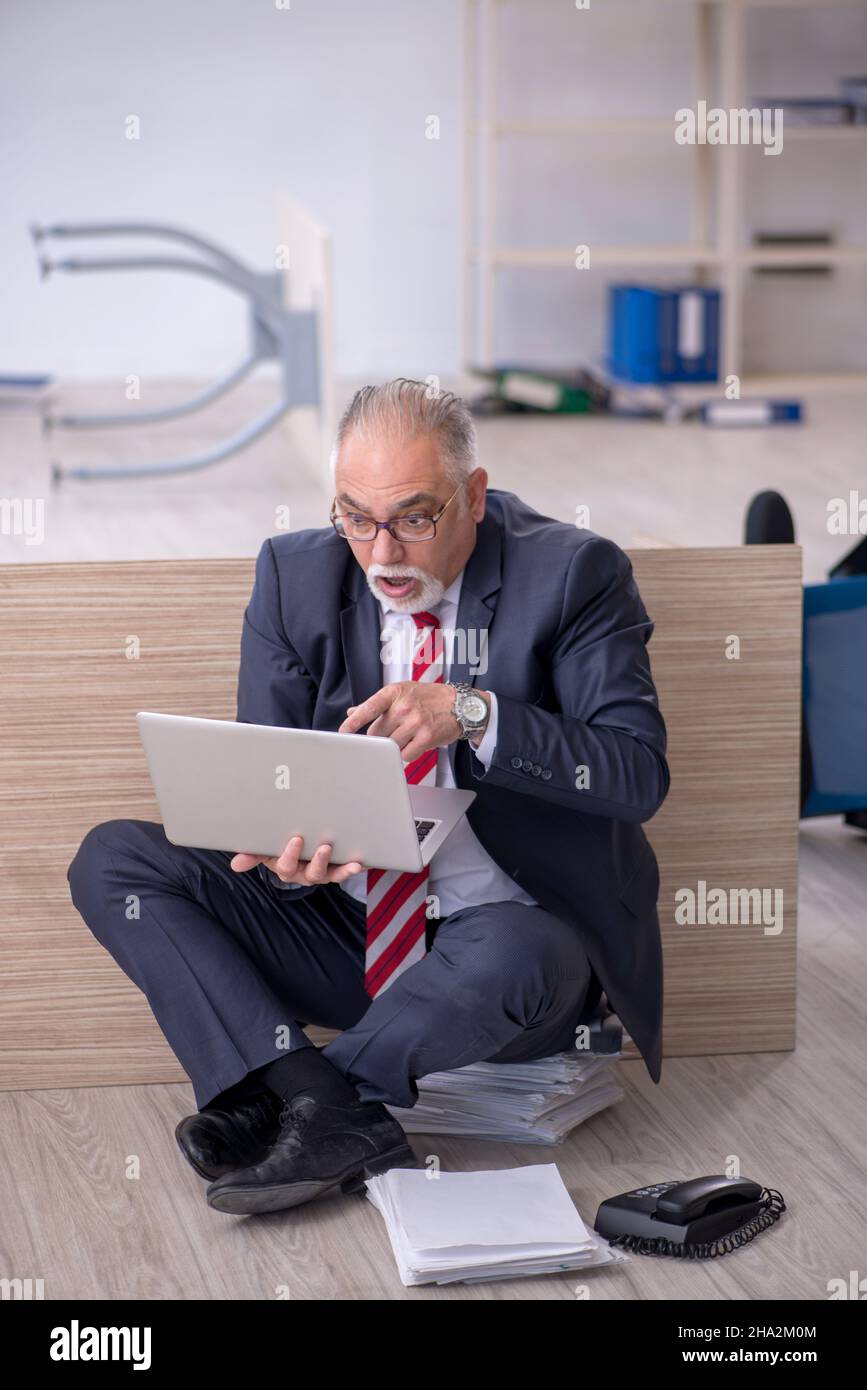 Old businessman employee working overtime at workplace Stock Photo - Alamy