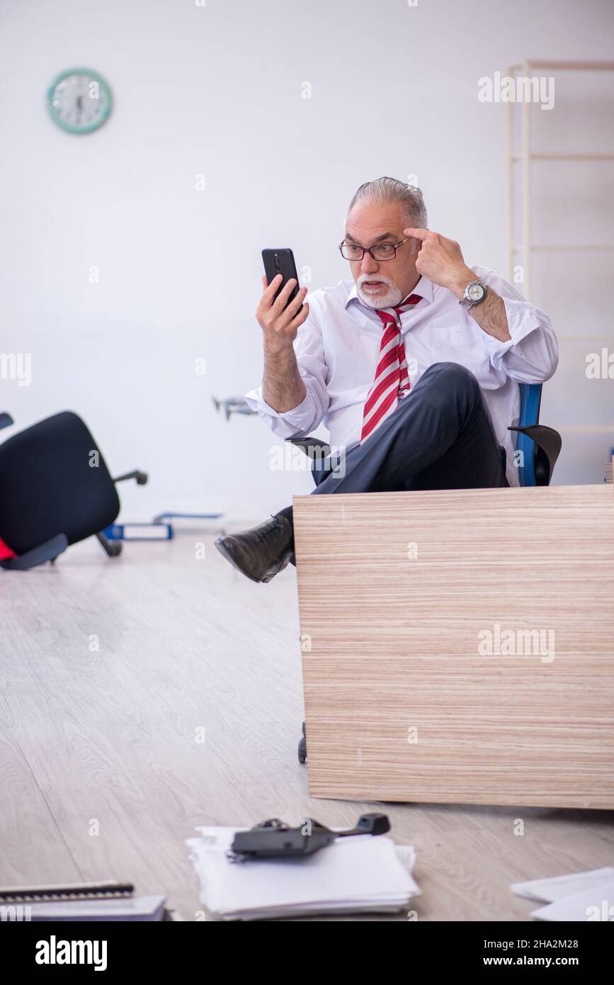 Old businessman employee working overtime at workplace Stock Photo - Alamy