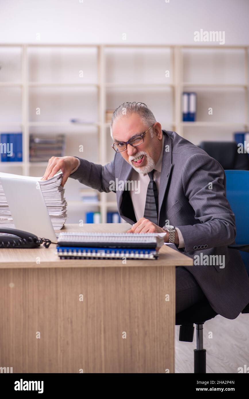 Old businessman employee working at workplace Stock Photo - Alamy