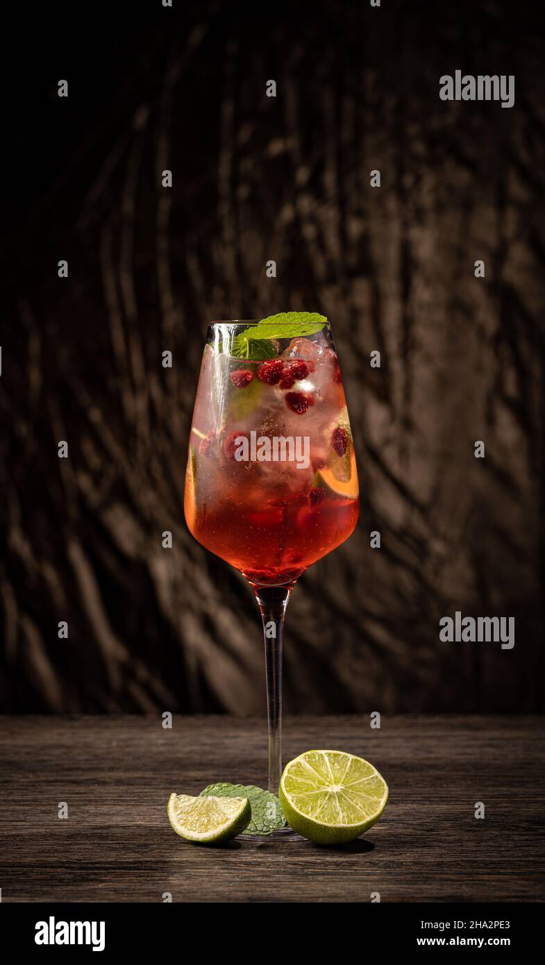 Raspberry lemonade with lime and ice. Cold refreshing cocktail Stock Photo