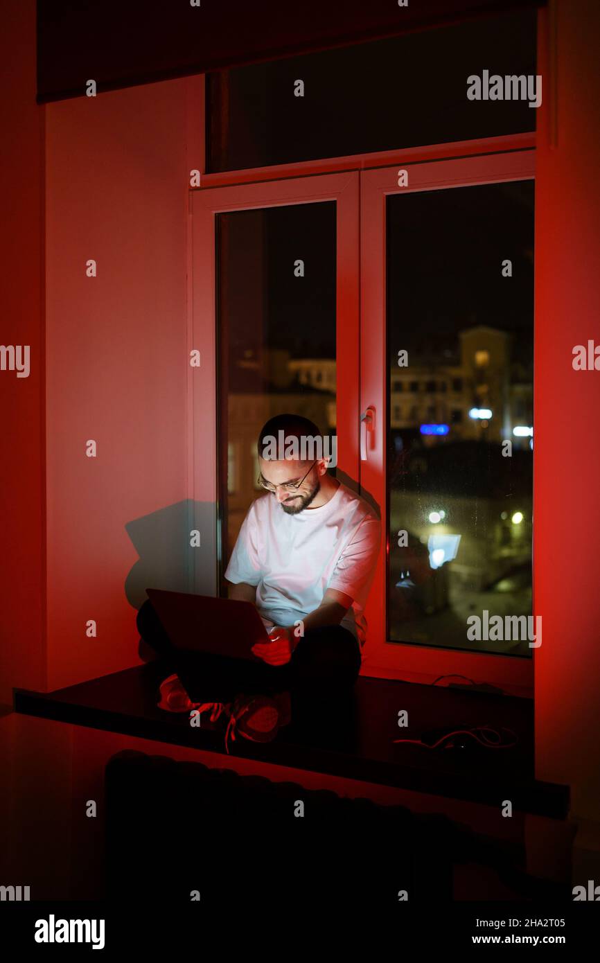Workaholic specialist work overtime. Programmer on remote outsource occupation. Nighttime lifestyle Stock Photo
