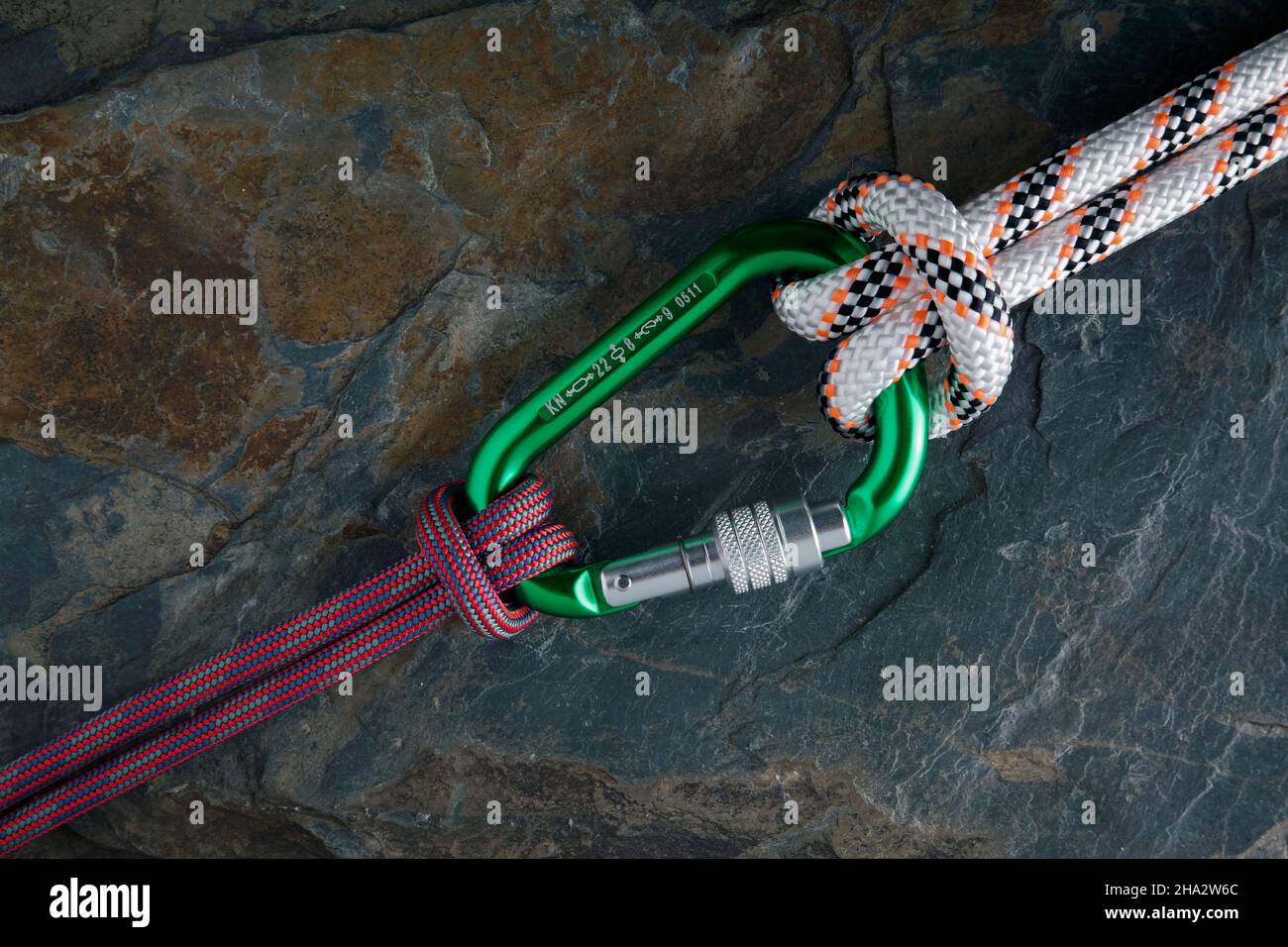 carabiner with a rope on stone surface Stock Photo