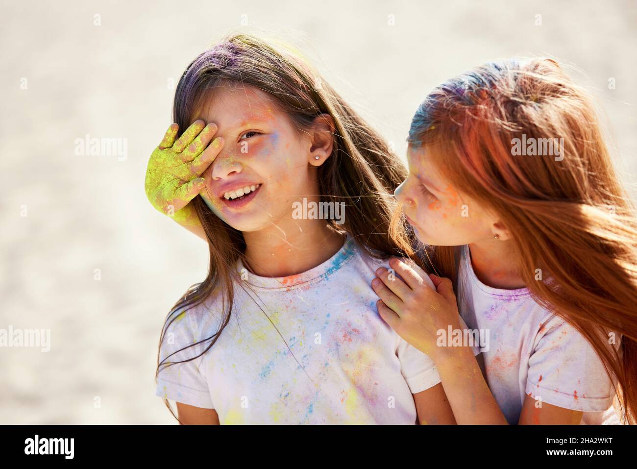 child girls smeared with colored powder having fun Stock Photo Alamy