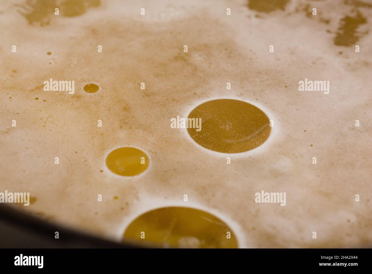 Closeup of a drop of vegetable oil on the surface of a broth or vegan