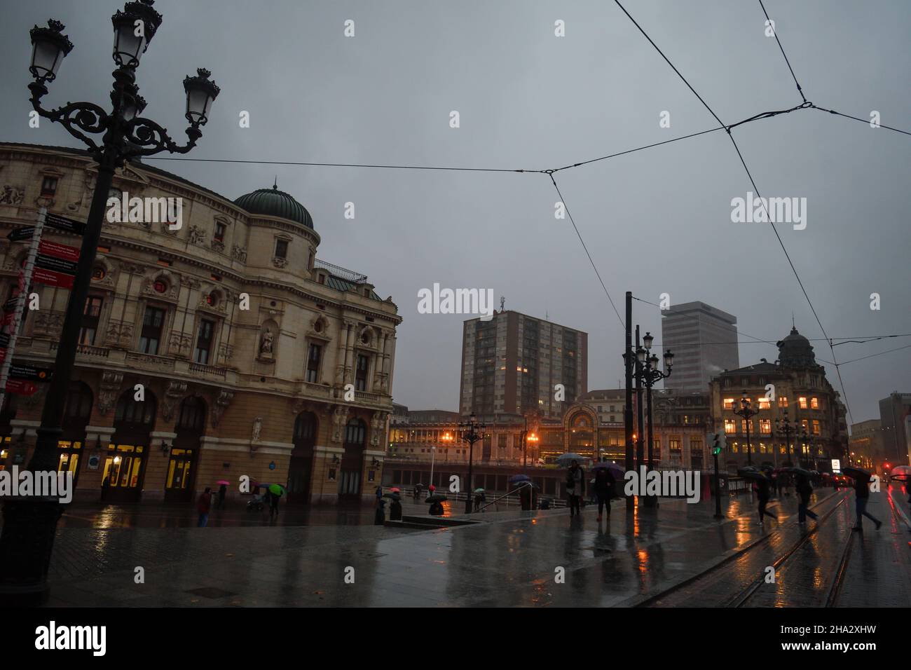 Arriaga Theater in Bilbao on a rainy evening next to the tram Stock Photo