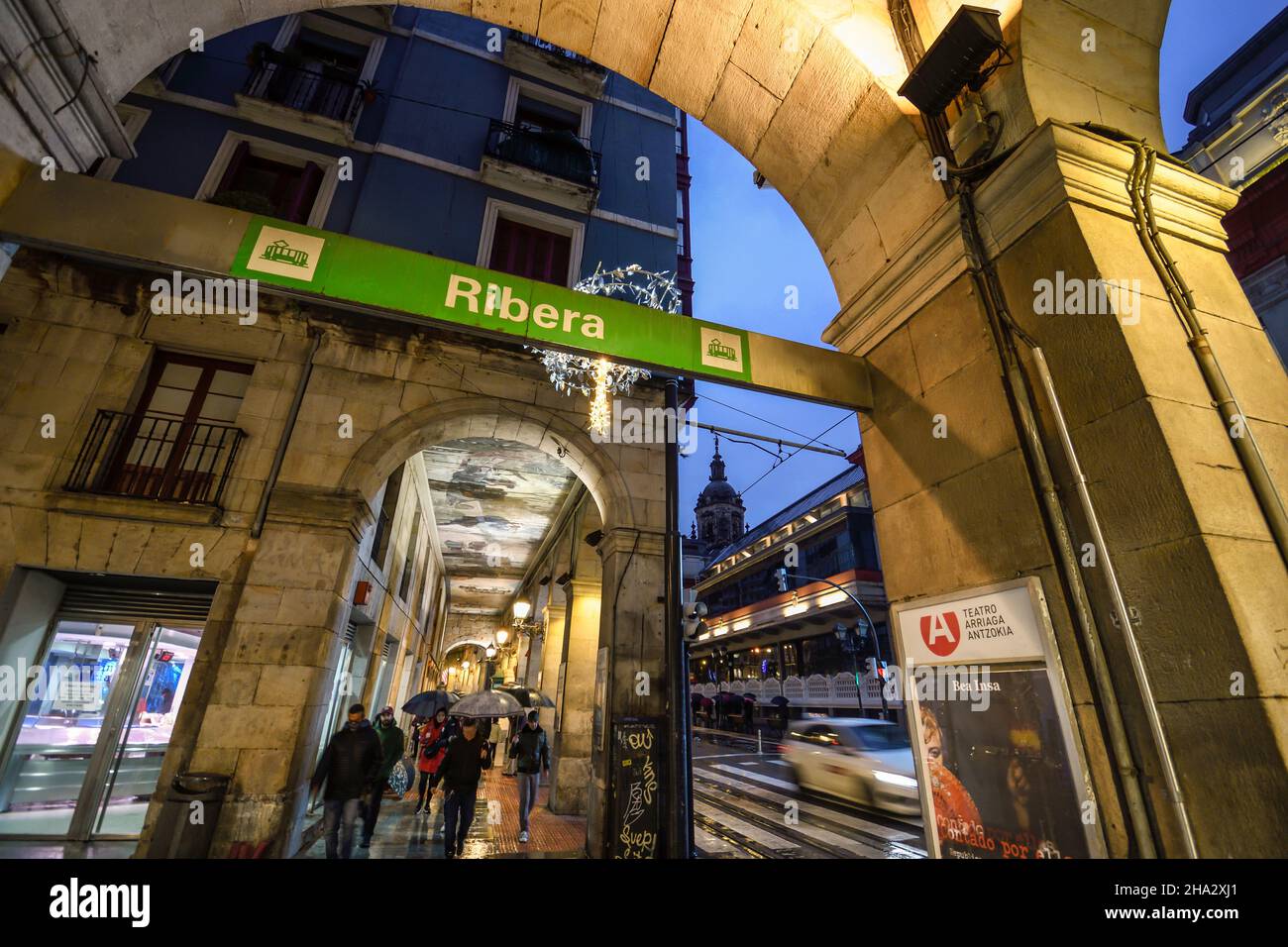 Portals of the old town of Bilbao next to the Mercado de la Ribera at dusk raining Stock Photo
