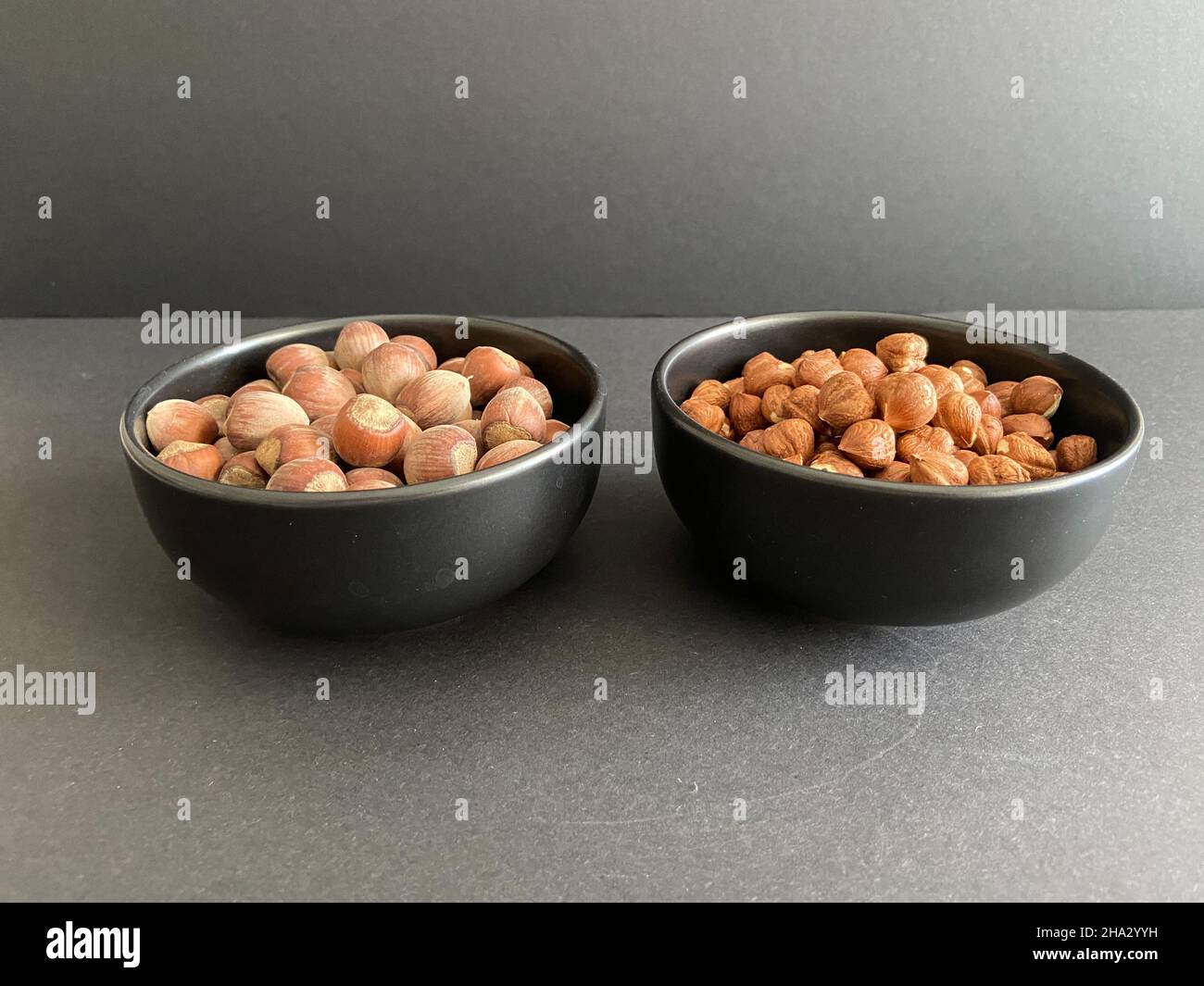 Nuts, hazelnuts in abowl with black background. Food concept and idea. Stock Photo