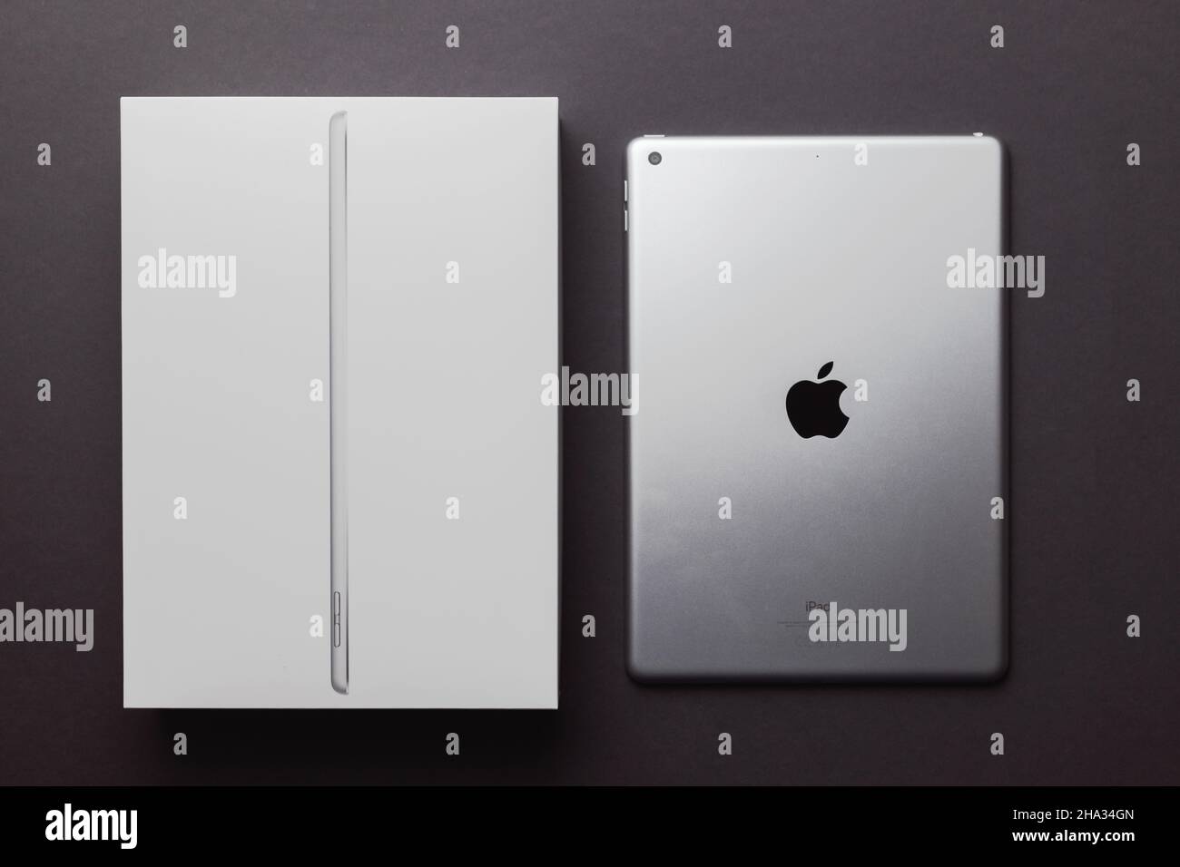 Minsk, Belarus- December 10, 2021: Apple Ipad 9 generation 10,2 inches 2021 silver color with package box on black backdrop Stock Photo