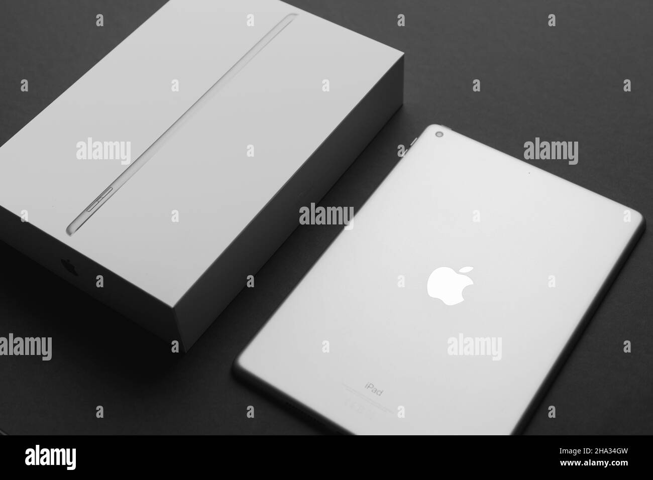 Minsk, Belarus- December 10, 2021: Apple Ipad 9 generation 10,2 inches 2021 silver color with package box on black backdrop Stock Photo
