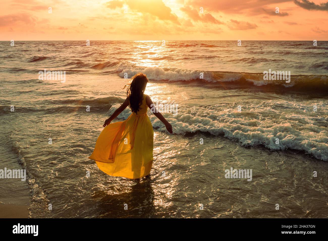 Seascape During Golden Sunrise With Beautiful Sky Woman On The Beach Young Happy Woman In A Yellow Fluttering Dress Walks Along The Seashore The Gi Stock Photo Alamy