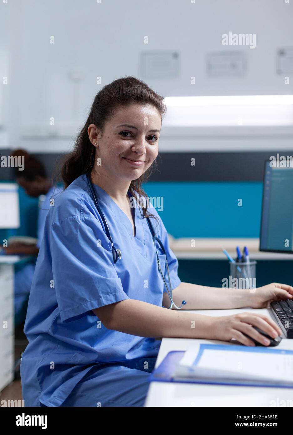 Portrait of pharmacist nurse with medical stethoscope analyzing pharmaceutical prescription