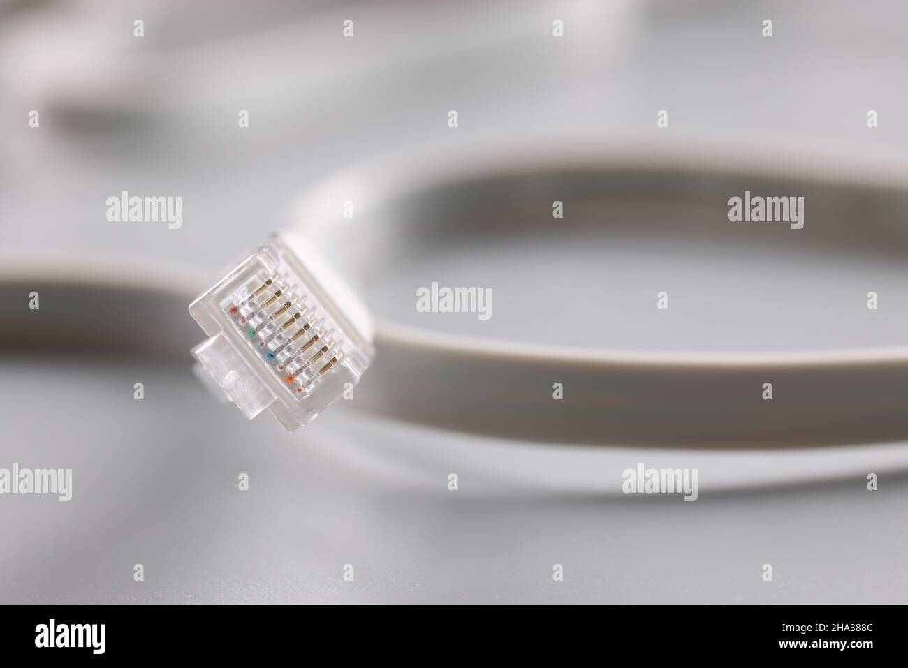 Computer patch cord cable on gray background. Fiber optic communication concept Stock Photo