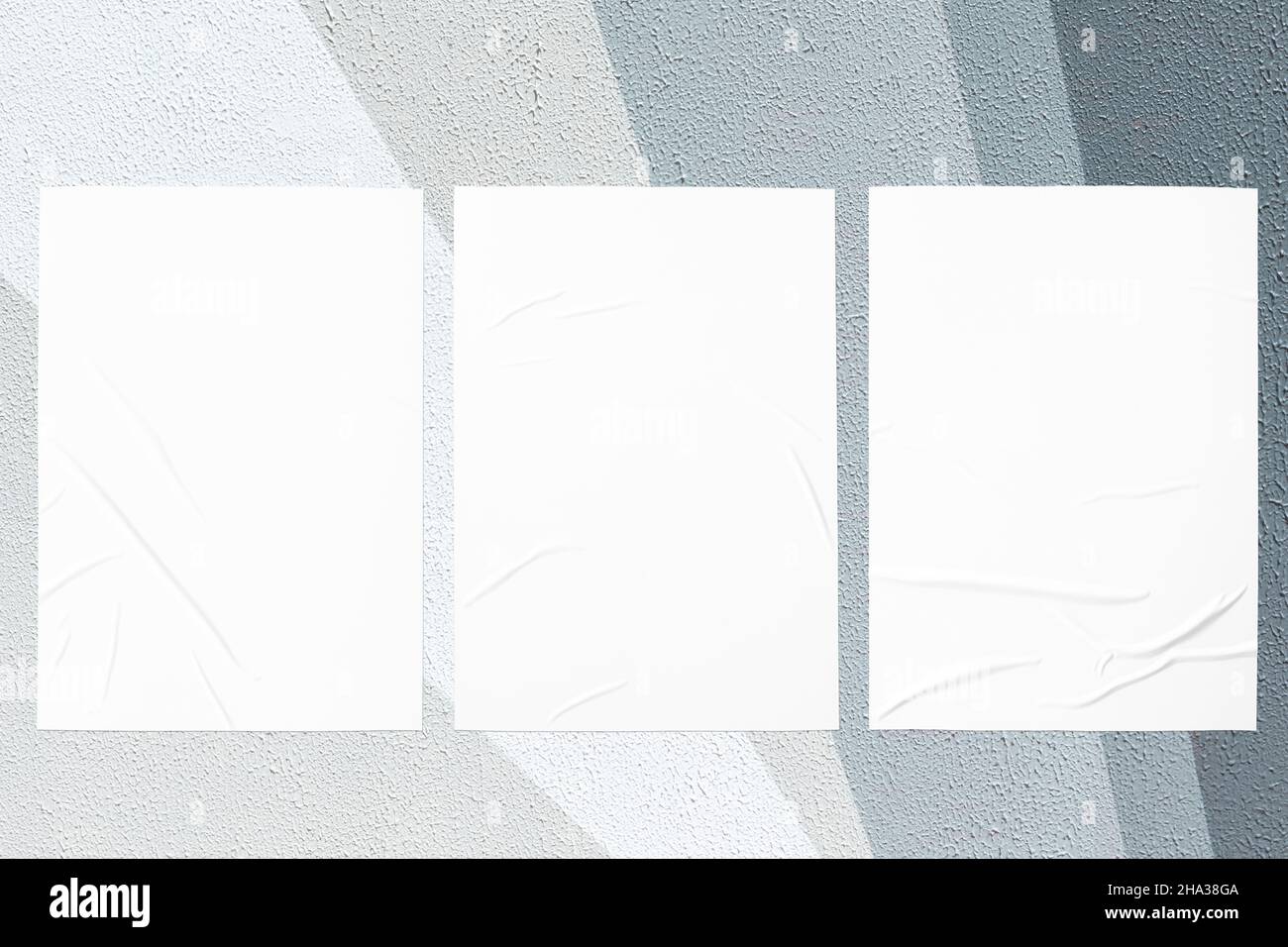gray painted urban wall with wrinkled glued poster templates Stock Photo