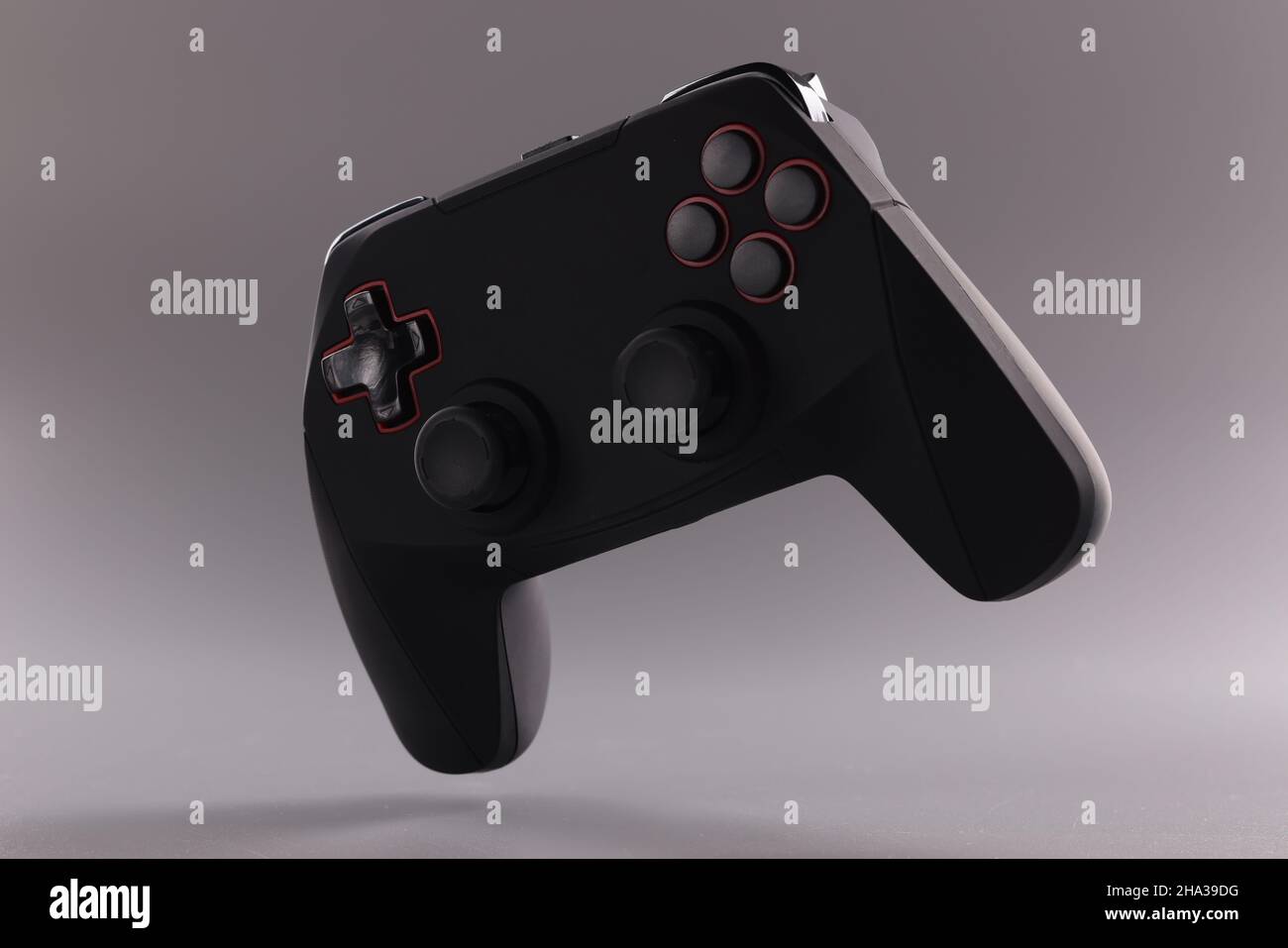 Black game joystick with buttons on gray background. Entertainment ...