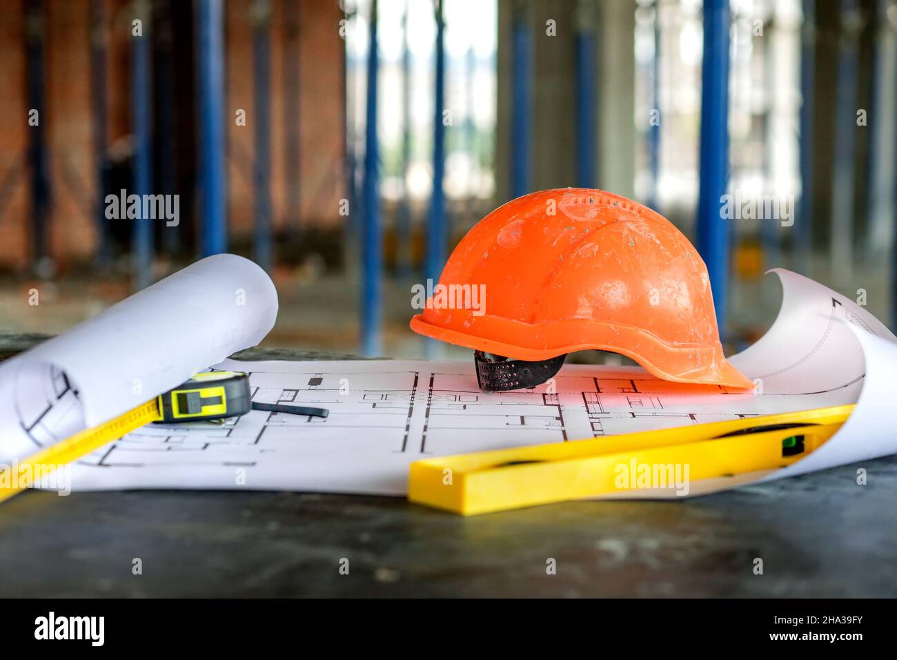 Blueprints project building, construction level and helmet, close up ...