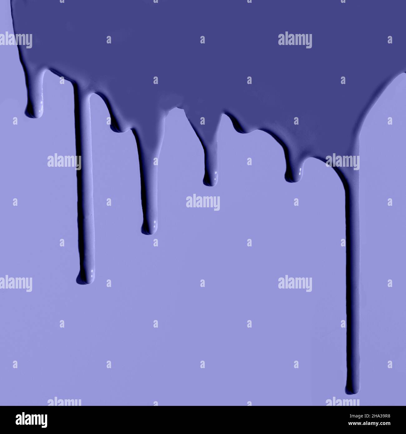 Pouring paint. Creative pattern with copy space. Trendy color very peri in the 2022 Year. Stock Photo