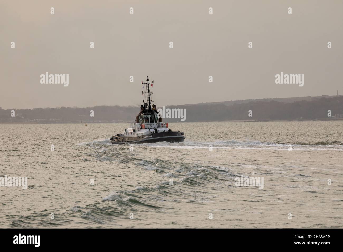Interesting wake left by the SERCO tug SD Bountiful as it crosses the Solent. Stock Photo