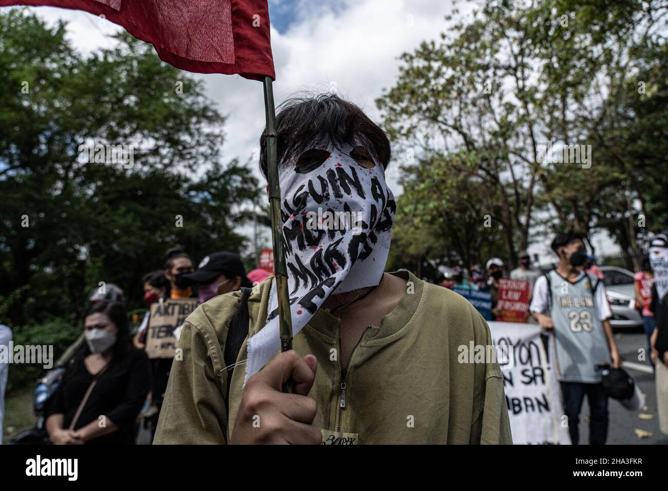 Human Rights Mask An activist wears a cloth mask calling for justice for human rights ...