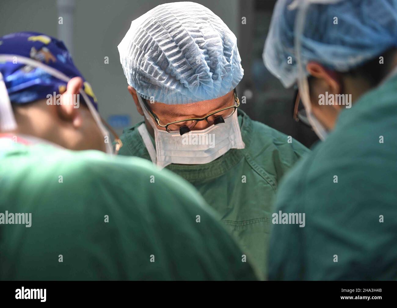 (211210) -- CHENGDU, Dec. 10, 2021 (Xinhua) -- Wang Wentao (C) uses the technology of extracorporeal hepatectomy plus liver autotransplantation in the treatment of a late-stage hydatid disease patient at a hospital in Tibetan Autonomous Prefecture of Garze, southwest China's Sichuan Province, Jan. 16, 2020.  Wang Wentao, deputy director of the liver surgery department at West China Hospital of Sichuan University, started his work on the prevention and control of hydatid disease in Tibetan Autonomous Prefecture of Garze in 2006 when he learned that some local people suffer from hydatid disease Stock Photo