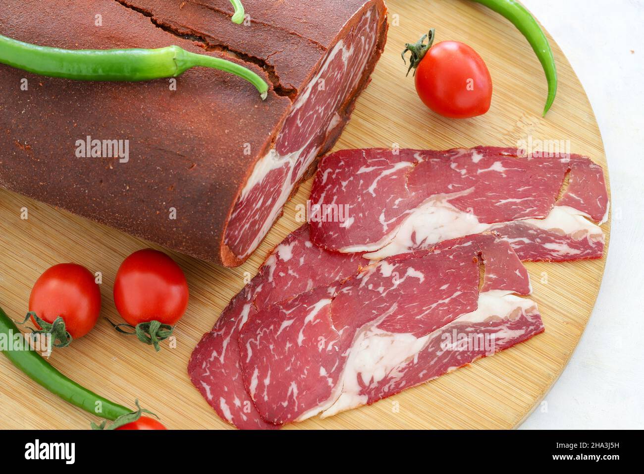 Turkish bacon , pastrami ( kayseri pastirma ) on wooden table Stock Photo