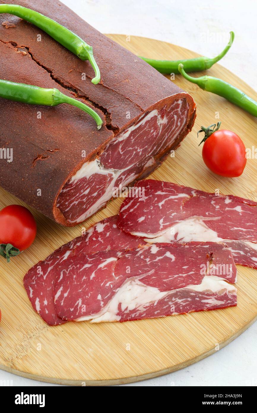 Turkish bacon , pastrami ( kayseri pastirma ) on wooden table Stock Photo
