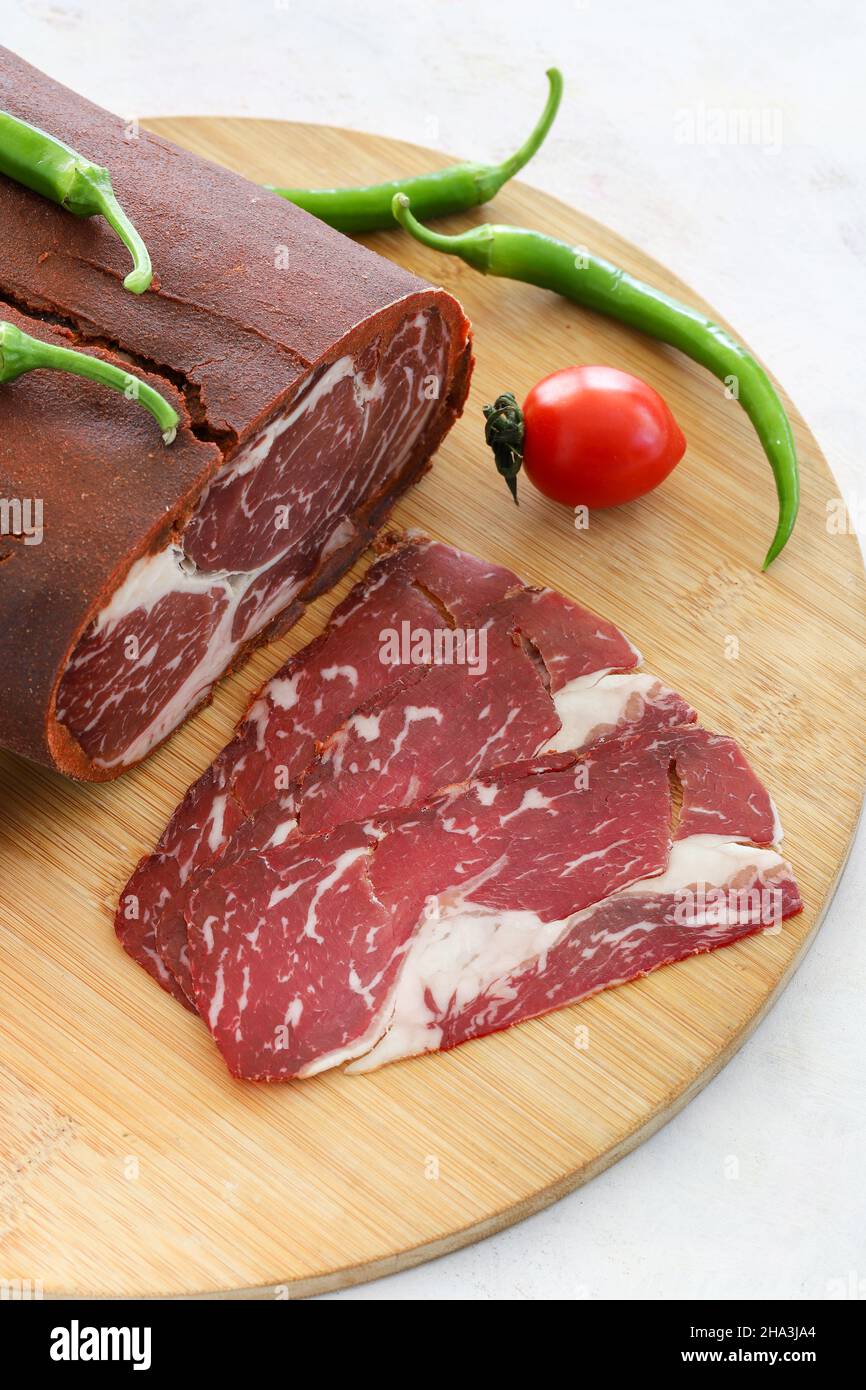 Turkish bacon , pastrami ( kayseri pastirma ) on wooden table Stock Photo